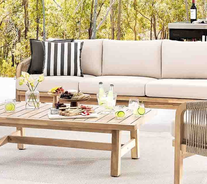 Seating and an outdoor kitchen set up outdoors in autumn.