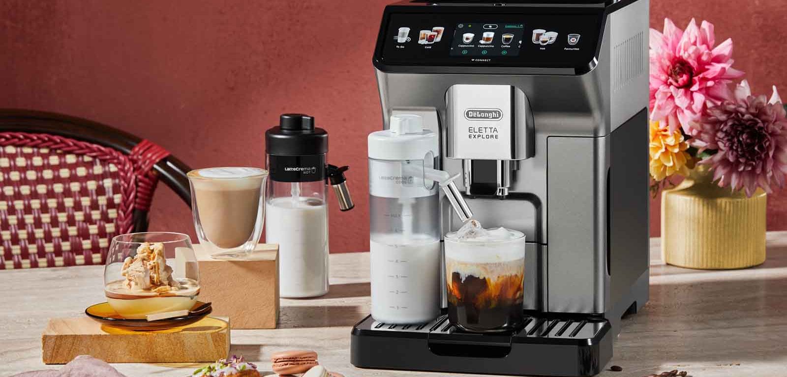 Coffee-Infused Madeleines + Macadamia Affogato recipes in front of the De'Longhi Eletta Explore Coffee Machine.