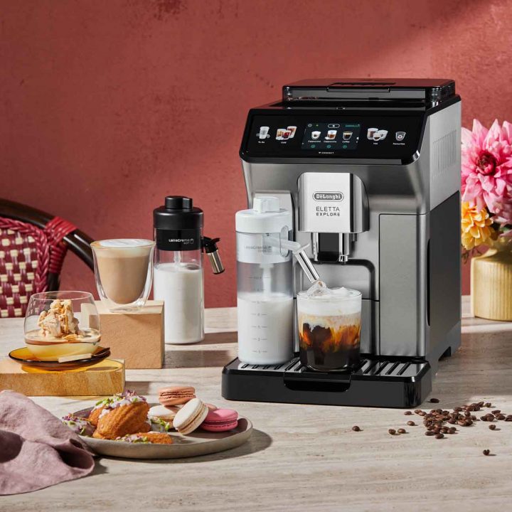 Coffee-Infused Madeleines + Macadamia Affogato recipes in front of the De'Longhi Eletta Explore Coffee Machine.