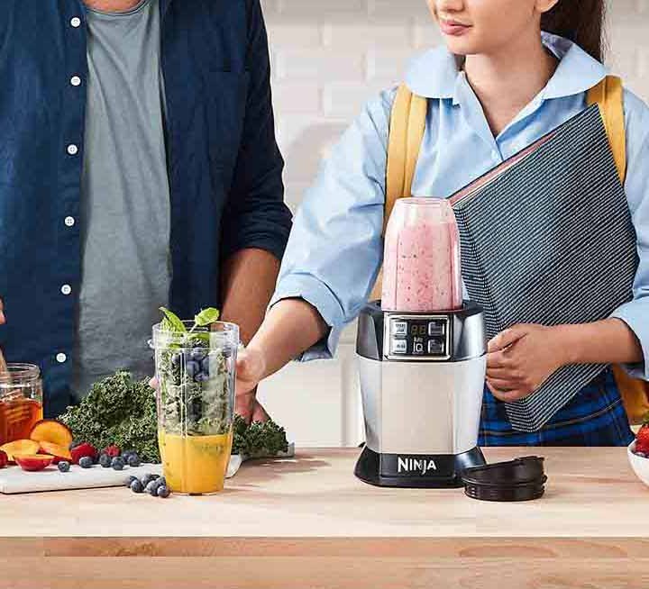 The Nutri Ninja Auto IQ Blender being used to make a Dairy-Free Berry Bliss Smoothie recipe.