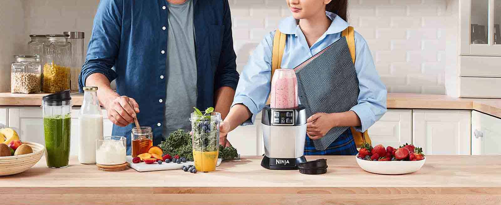 The Nutri Ninja Auto IQ Blender being used to make a Dairy-Free Berry Bliss Smoothie recipe.
