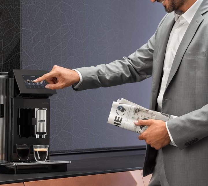 Man operating the De'Longhi Maestosa Coffee Machine.
