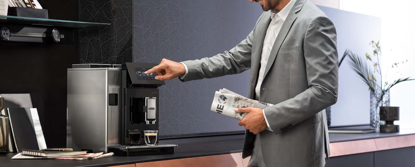 Man operating the De'Longhi Maestosa Coffee Machine.