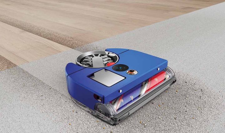 The Dyson 360 Vis Nav Robot Vacuum cleaning dirt off the floor.