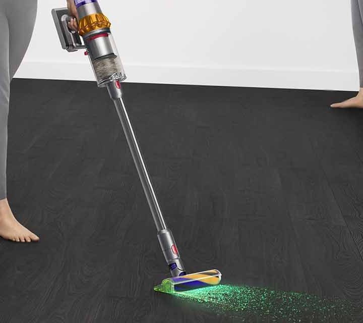 A person using the Dyson V15 Detect Total Clean.