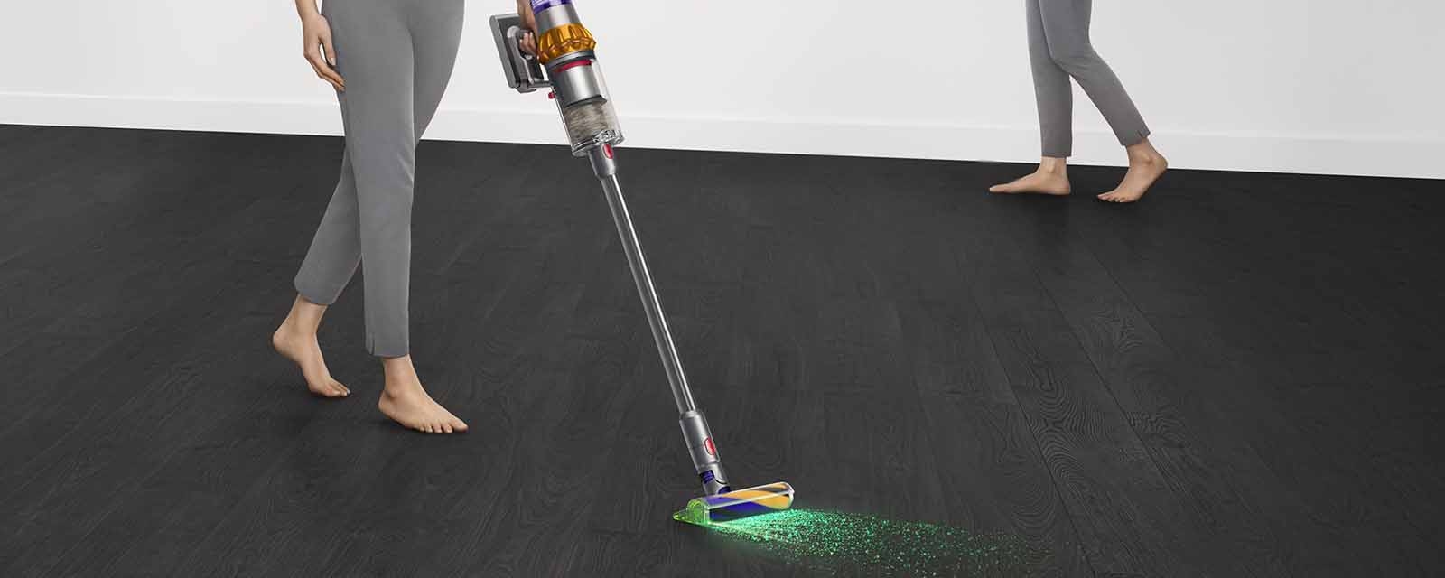 A person using the Dyson V15 Detect Total Clean.