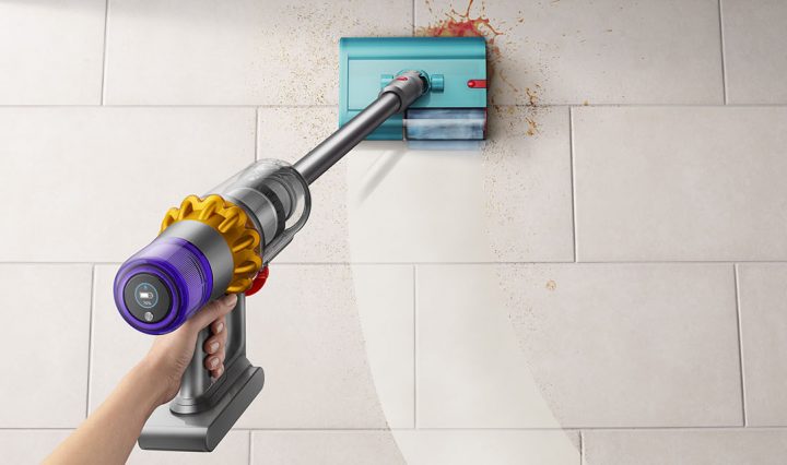 The Dyson V15S Submarine being used to clean a spill on a kitchen floor.