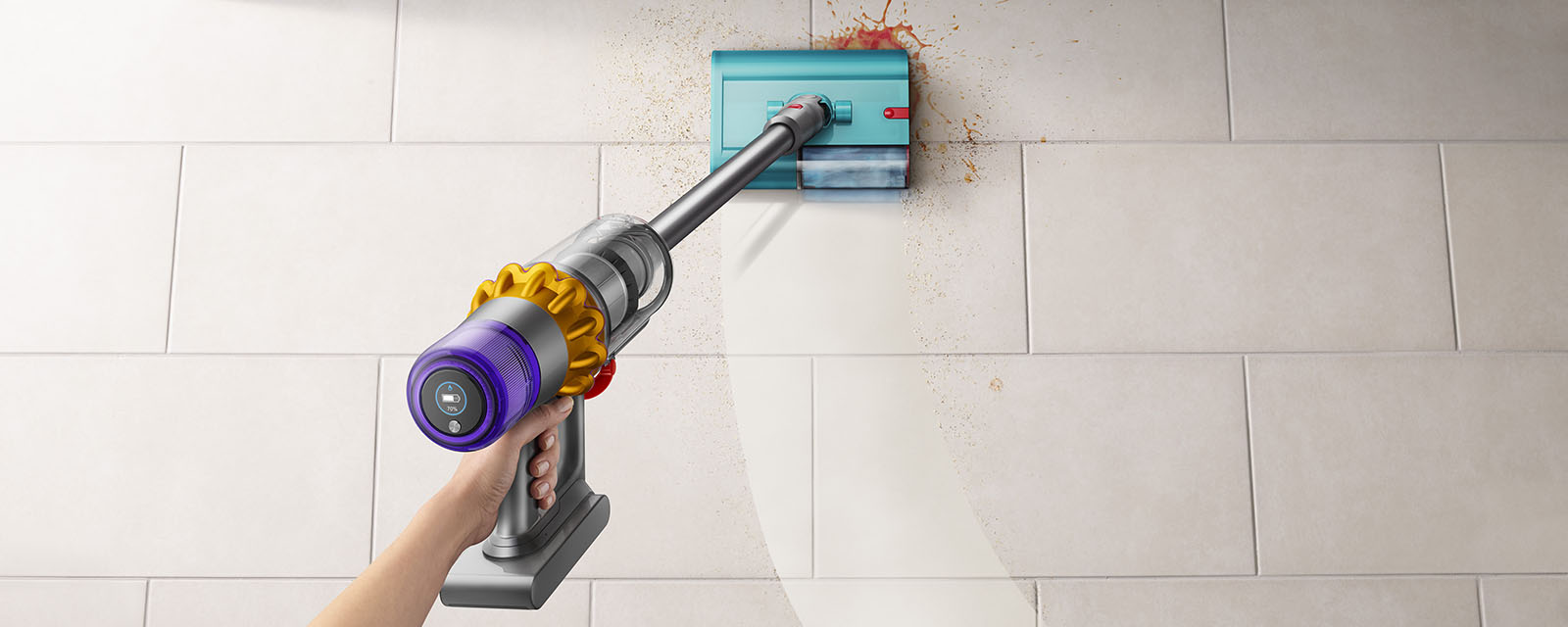 The Dyson V15S Submarine being used to clean a spill on a kitchen floor.