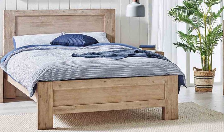 Complementary timber bed, tallboy and bedside table in a bedroom.