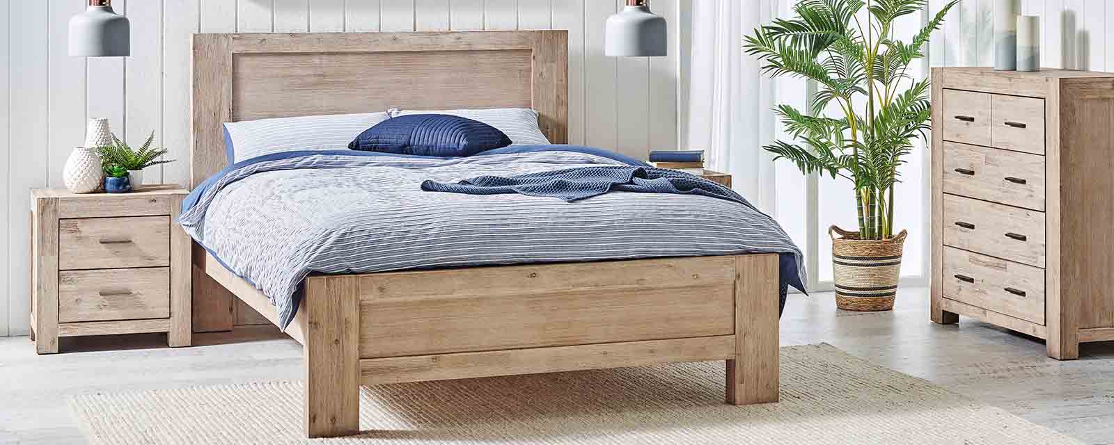 Complementary timber bed, tallboy and bedside table in a bedroom.