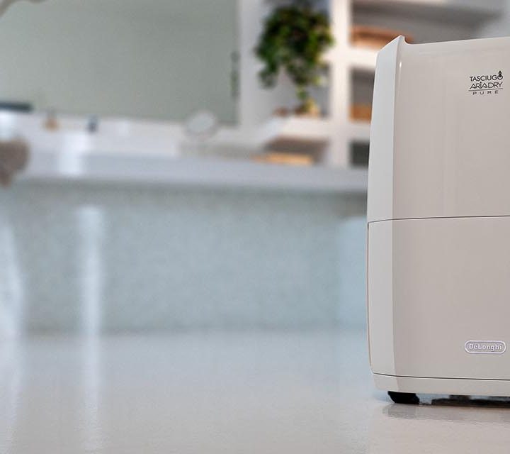 DeLonghi Tasciugo AriaDry Pure 2-in-1 Dehumidifier & Air Purifier in a bathroom.