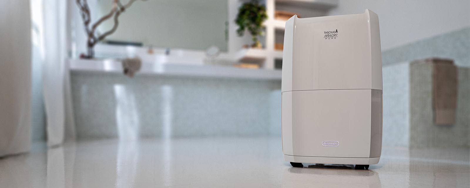 DeLonghi Tasciugo AriaDry Pure 2-in-1 Dehumidifier & Air Purifier in a bathroom.
