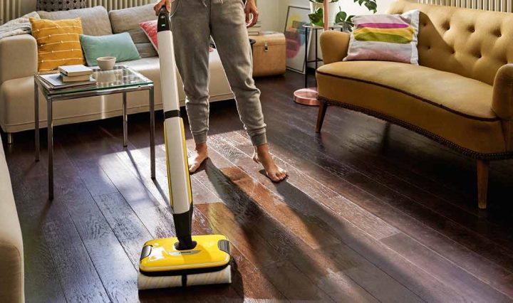 Person cleaning a living room with the Karcher FC7 Hard Floor Cleaner.