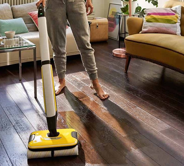 Person cleaning a living room with the Karcher FC7 Hard Floor Cleaner.