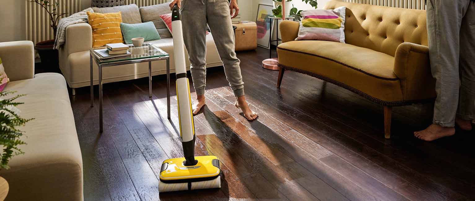 Person cleaning a living room with the Karcher FC7 Hard Floor Cleaner.