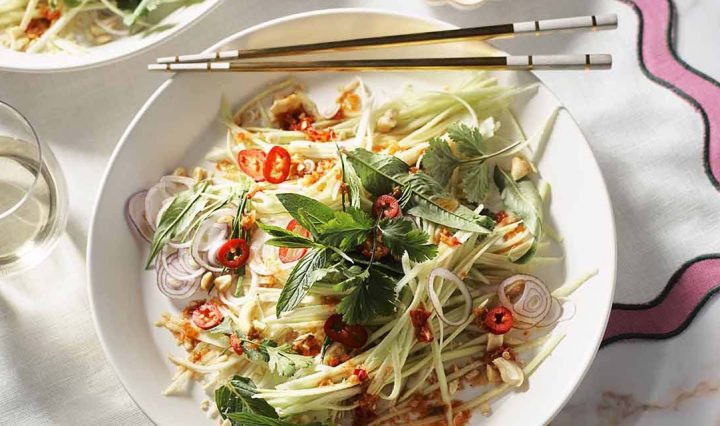 Plated Mango Green Salad with chopsticks.
