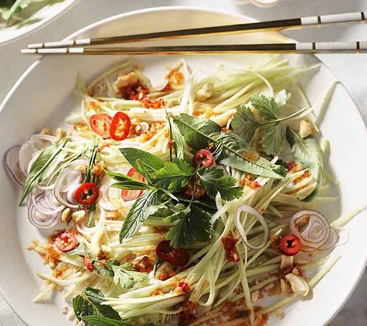 Plated Mango Green Salad with chopsticks.