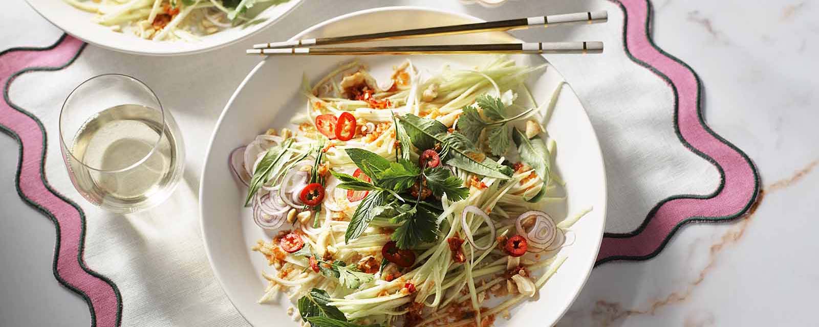 Plated Mango Green Salad with chopsticks.