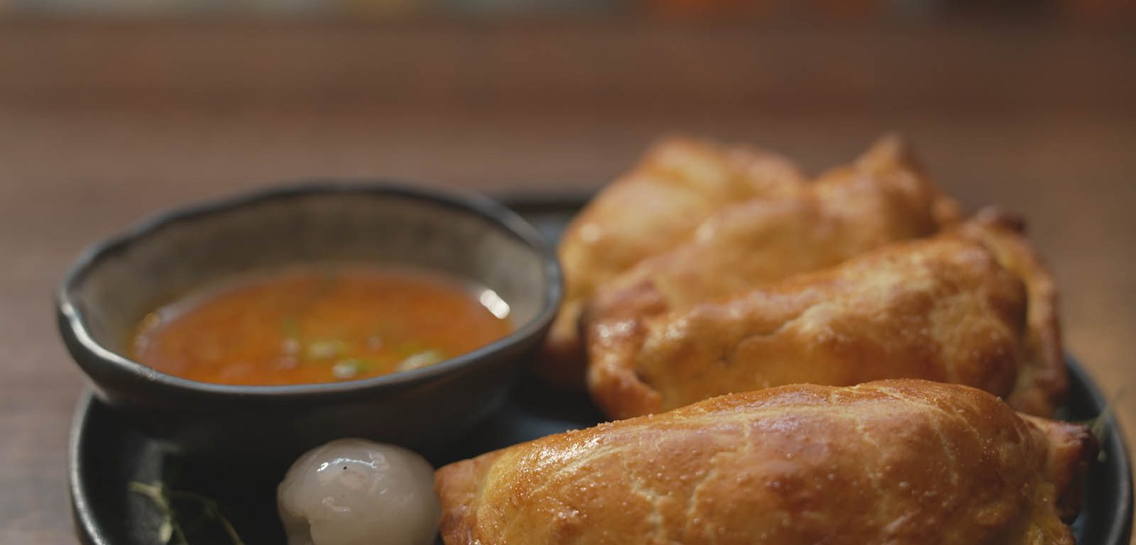 Quail + Nduja Empanadas on a plate.