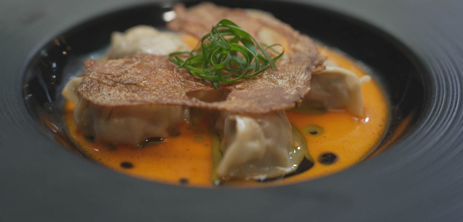 Quail + Nectarine Dumplings in a bowl.