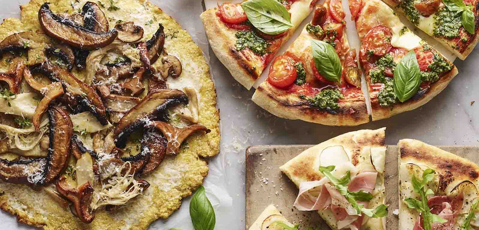 Three pizzas with cauliflower bases.