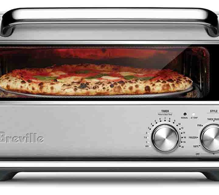 The Smart Oven Pizzaiolo by Breville surrounded by pizzas!