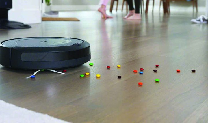 iRobot Roomba i3+ Robotic Vacuum cleaning smarties off the floor.