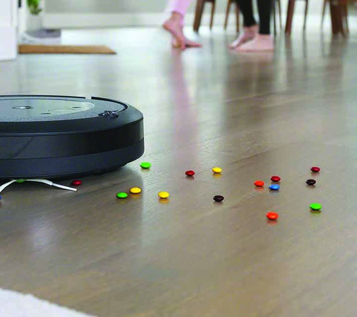 iRobot Roomba i3+ Robotic Vacuum cleaning smarties off the floor.
