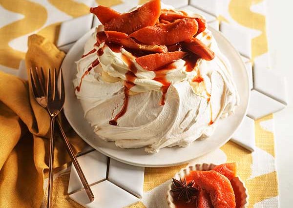 Pavlova with wattleseed crème patisserie, cream and poached quince.