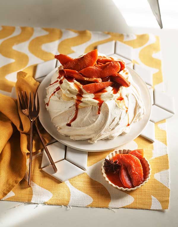 Pavlova with wattleseed crème patisserie, cream and poached quince.