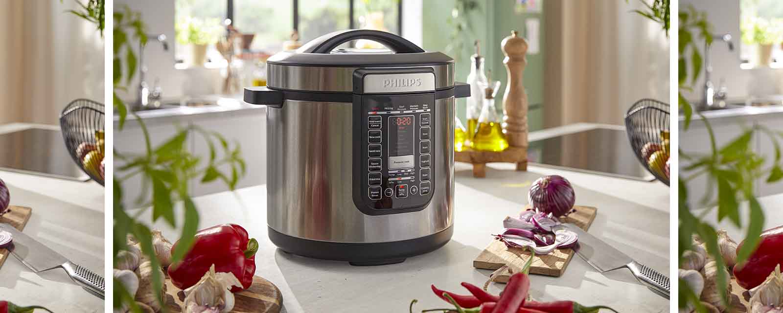 The Philips 8L All In One Cooker next to vegetables.