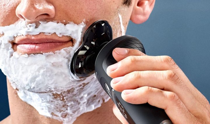 A man shaving his face with the Philips Series 9000 Prestige Shaver .