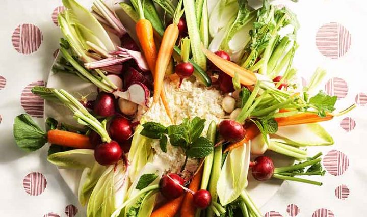 Raw vegetable plate with buttermilk ricotta and green sauce.