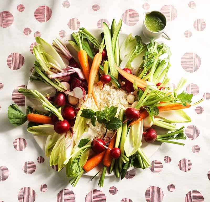 Raw vegetable plate with buttermilk ricotta and green sauce.