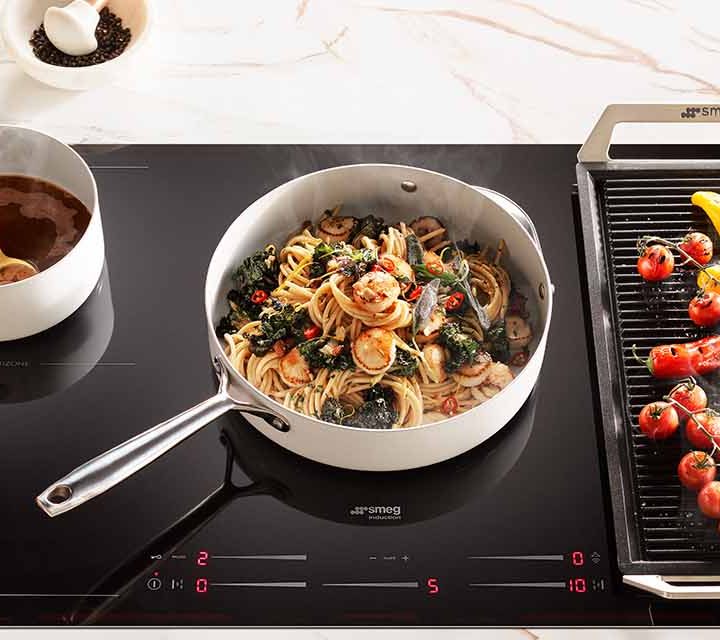 Abrolhos Island Scallop Bucatini cooking on the Smeg 900mm 5 Zone Induction Cooktop.