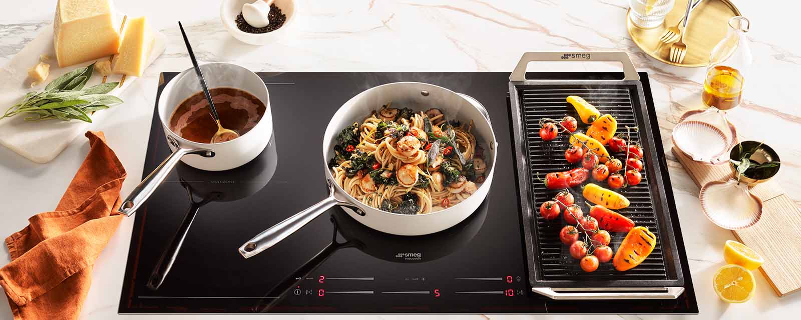 Abrolhos Island Scallop Bucatini cooking on the Smeg 900mm 5 Zone Induction Cooktop.