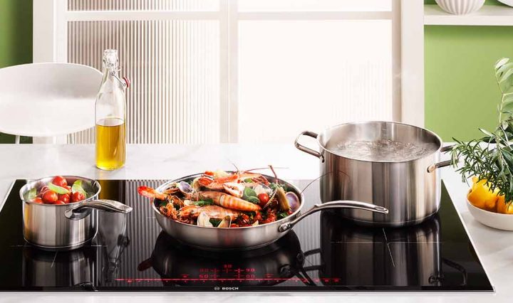 Braised seafood, fennel & saffron with aioli & warrigal greens cooking on the Bosch 900mm Series 8 5 Zone Induction Cooktop.