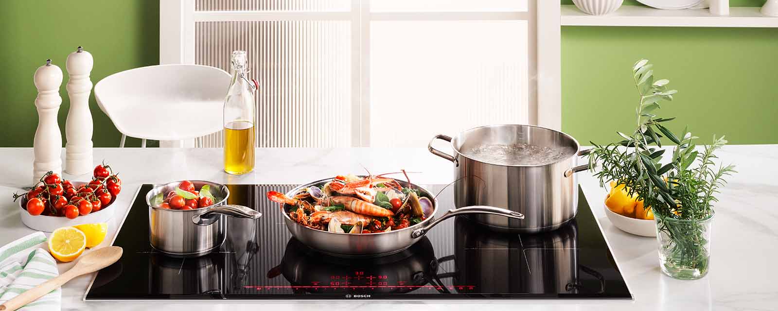 Braised seafood, fennel & saffron with aioli & warrigal greens cooking on the Bosch 900mm Series 8 5 Zone Induction Cooktop.