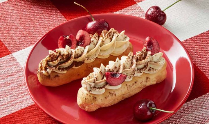Cherry Mocha Eclairs on a red and white tablecloth.