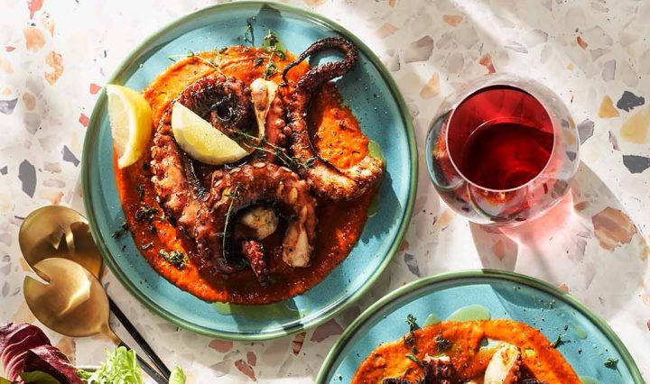 Grilled Octopus on plate with lemon.