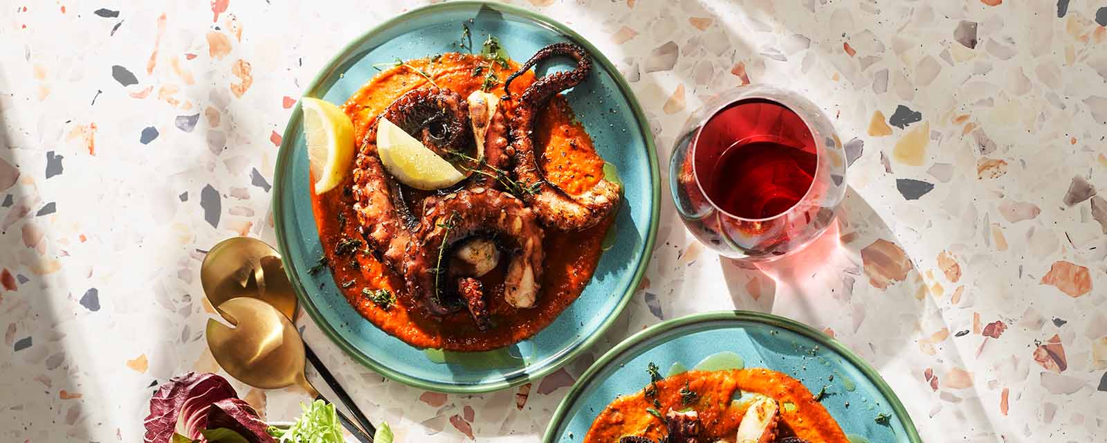 Grilled Octopus on plate with lemon.