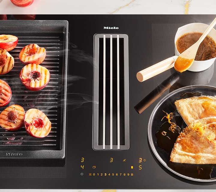 Orange Crepe Suzette being cooked on a Miele 800mm 4 Zone Induction Cooktop with Vapour Extraction.