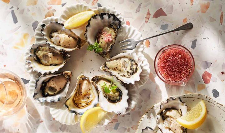 Oysters on a plate with lemons.