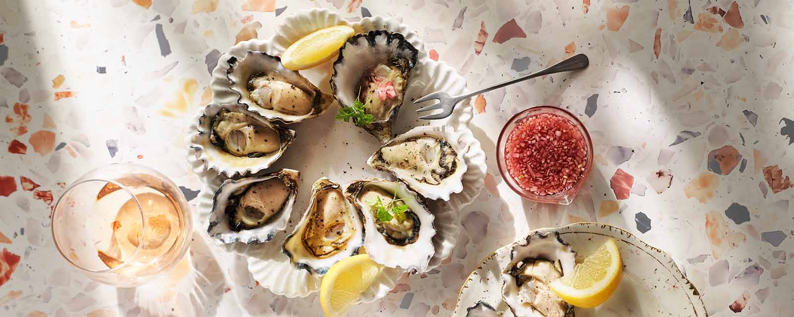 Oysters on a plate with lemons.