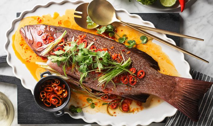 Steamed Coral Trout on a kitchen bench.