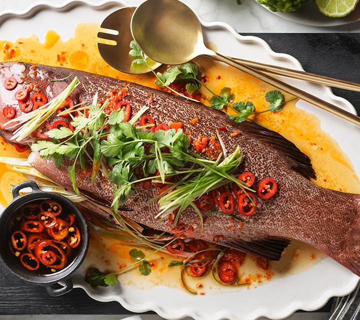 Steamed Coral Trout on a kitchen bench.