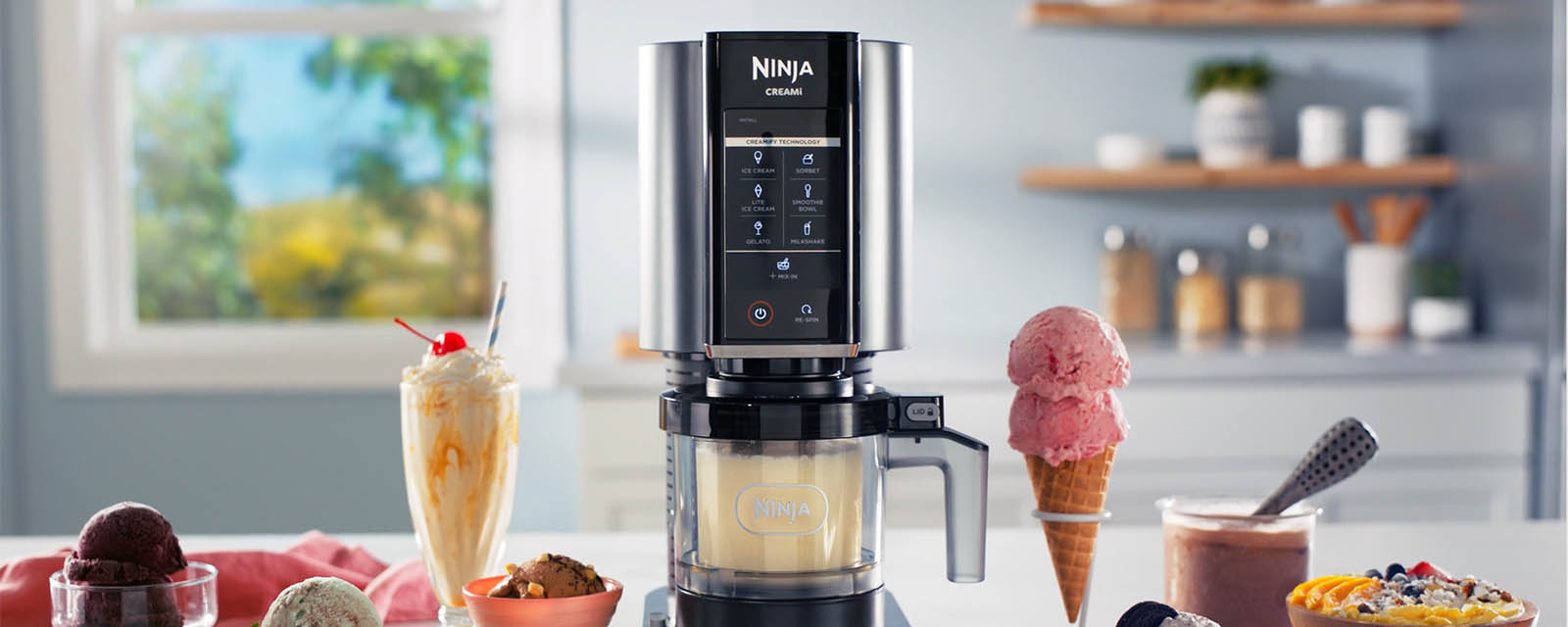 The Ninja Creami Ice Cream Maker next to an ice cream cone and milkshake.