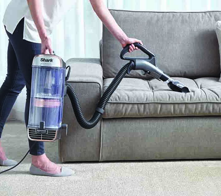 Cleaning a lounge with the Shark PZ1000 Vacuum Cleaner.
