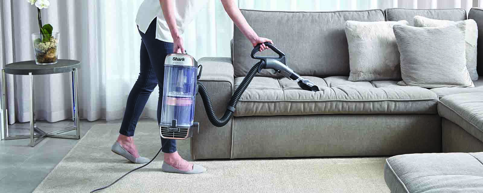 Cleaning a lounge with the Shark PZ1000 Vacuum Cleaner.