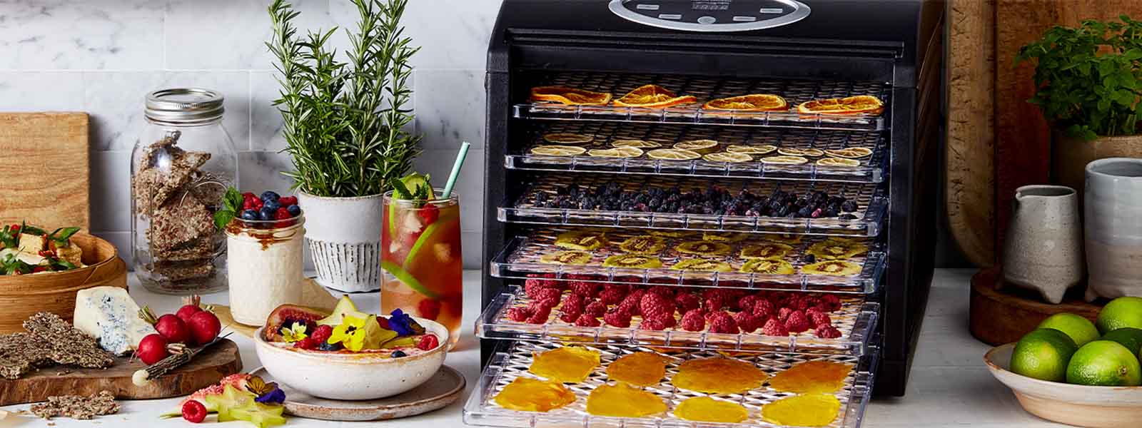 The Sunbeam Food Lab Electronic Dehydrator with various food on each shelf.